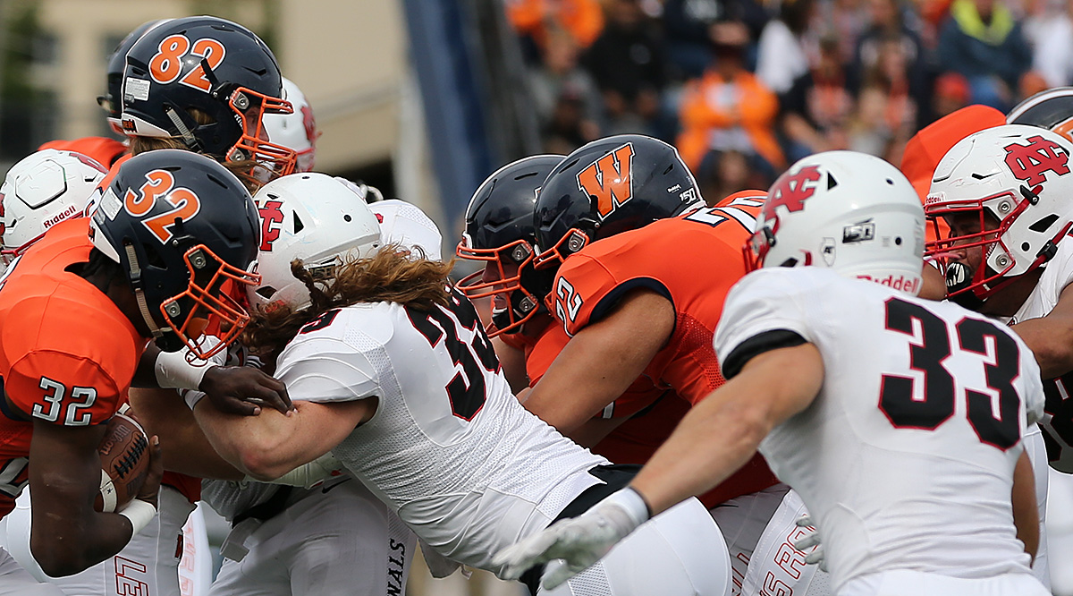 Wheaton and North Central battling at the line of scrimmage in their 2019 meeting.